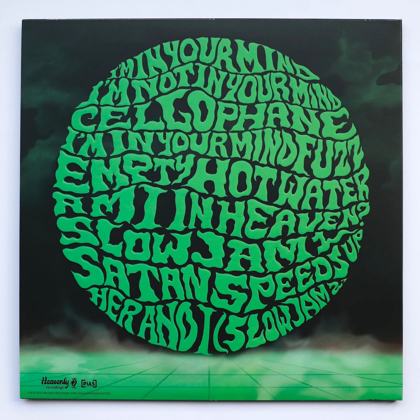 Vinyl record cover with green text design on a black background