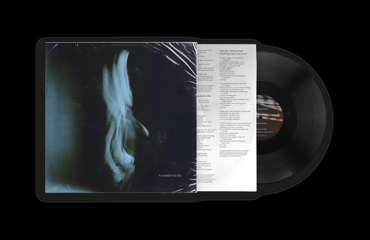 Vinyl record with cover featuring artistic design and text on a black background