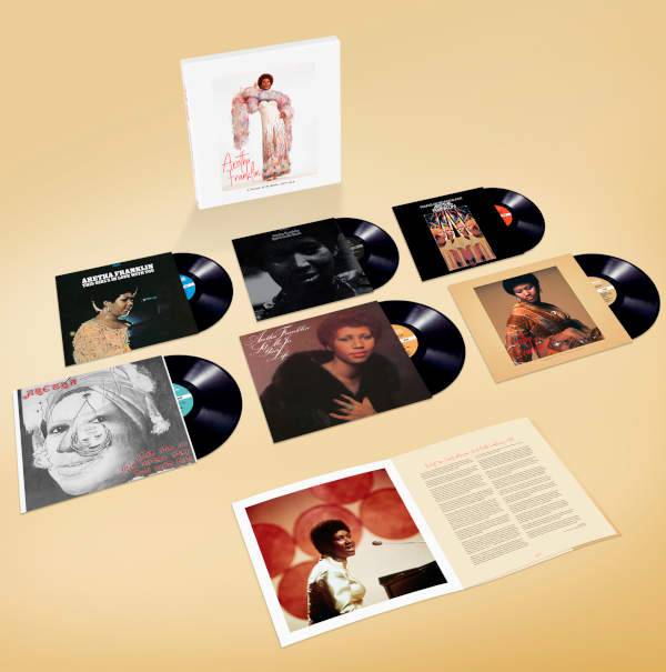 Collection of vinyl records and album covers on a beige background
