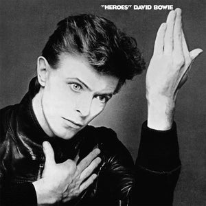 Black and white album cover featuring a person with hands near face, with 'Heroes' by David Bowie text.