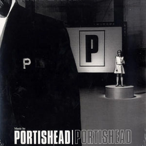 Album cover for Portishead featuring a large figure with 'P' and a smaller figure on a stage.